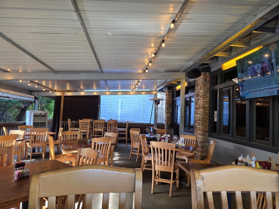 Restaurant exterior with parking and outdoor seating.